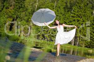 Happy romantic woman with parasol in sunlight