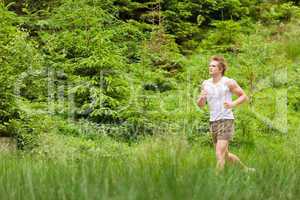 Morning run: Young man jogging in nature