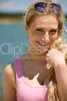 Smiling blond woman enjoy summer sun wearing sunglasses