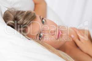 White lounge - Naked blond woman lying in white bed