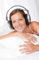 Young woman in white with headphones
