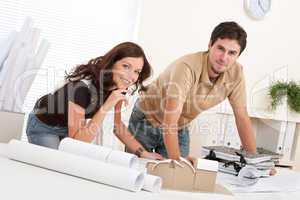Young man and woman working at architect office