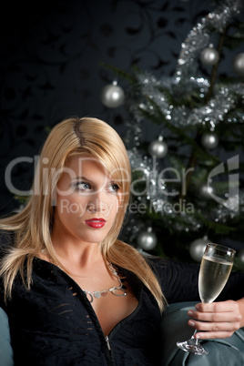 Blond woman with glass of champagne on Christmas