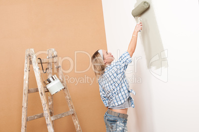 Home improvement: Blond woman painting wall