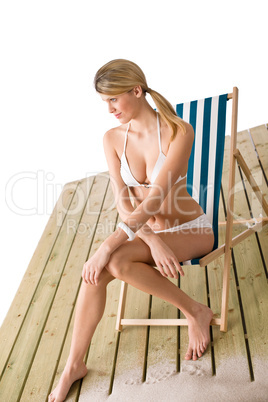 Beach - Woman in bikini sunbathing on deck chair