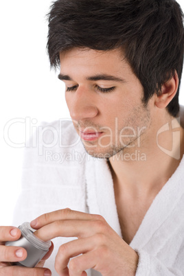 Facial care - Young man applying moisturizer