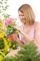 Gardening - Happy woman holding flower pot