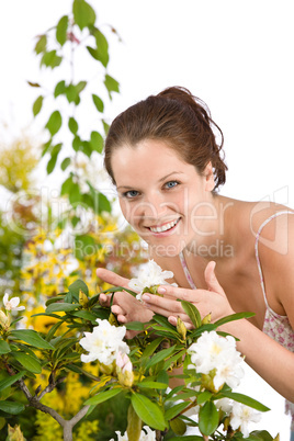 Gardening - Woman with Rhododendron flower blossom