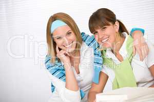 Student at home - two young woman study together