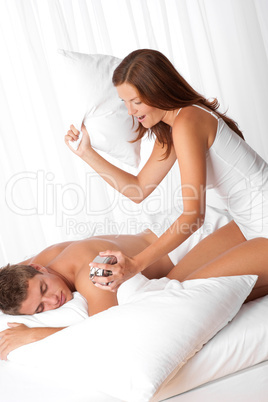 Brown hair woman waking up her man