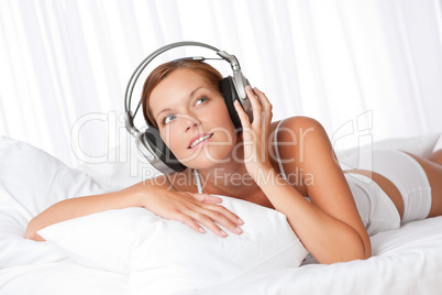 Young woman in white with headphones