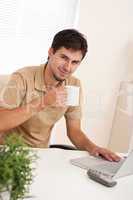 Successful modern businessman with cup of coffee