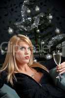Portrait of blond sexy woman with champagne on Christmas