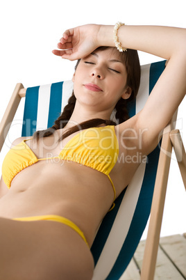 Beach - Beautiful woman sunbathing in bikini on deckchair