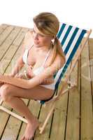 Beach - Woman in bikini sunbathing on deck chair