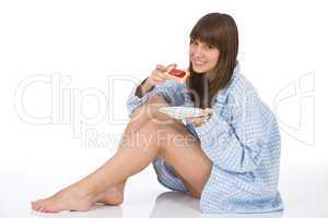 Happy teenager eating healthy toast for breakfast