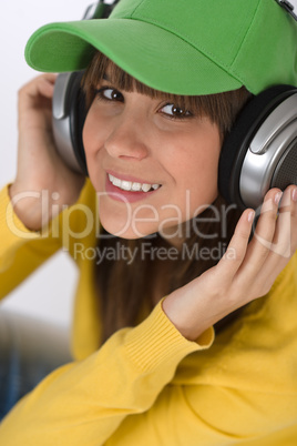 Happy female teenager enjoy music