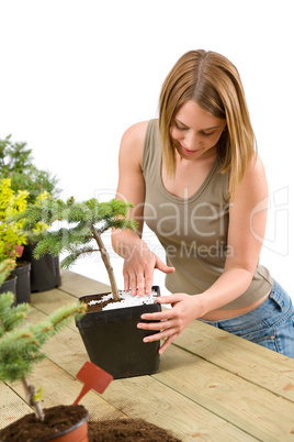 Gardening - woman with bonsai tree and plants