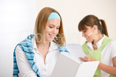 Student at home - two young woman study together