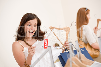 Fashion shopping -  Two happy woman choose sale clothes