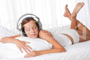 Young woman in white with headphones