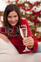 Brown hair woman sitting with glass of champagne on Christmas