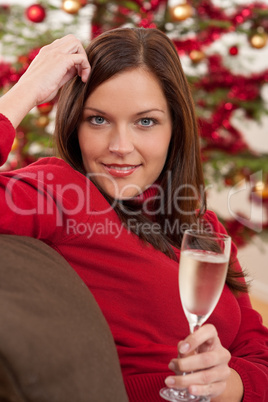 Attractive brown hair woman in front of Christmas tree