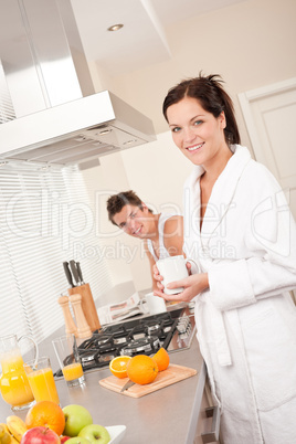 Smiling woman having coffee for breakfast