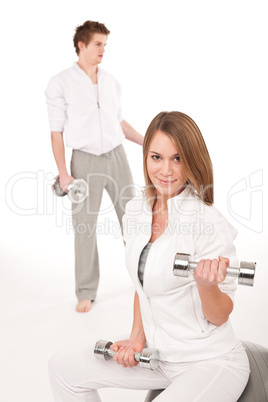 Fitness - Young couple training with weights and ball