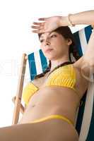 Beach - Beautiful woman sunbathing in bikini on deckchair
