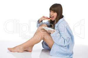 Happy teenager eating healthy toast for breakfast