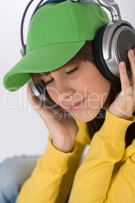 Happy female teenager enjoy music