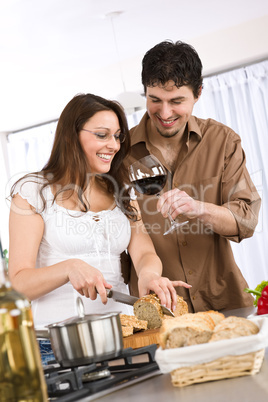 Cooking - happy couple together in modern kitchen