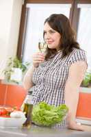 Cook - Plus size happy woman with white wine and lettuce