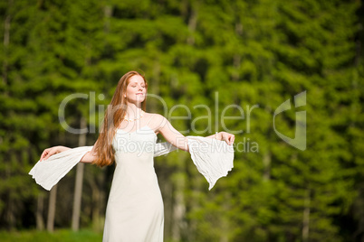 Beautiful romantic woman in summer sunny nature