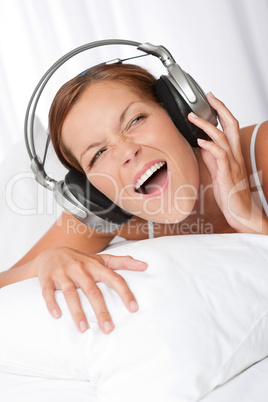 Young woman in white with headphones