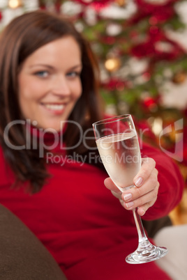 Attractive brown hair woman in front of Christmas tree