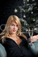 Blond woman with glass of champagne on Christmas