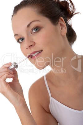 Body care series - Young woman applying lipstick