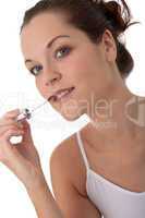 Body care series - Young woman applying lipstick