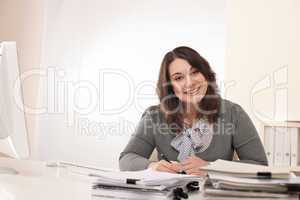 Young smiling business woman working at office