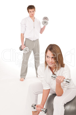 Fitness - Young couple training with weights and ball