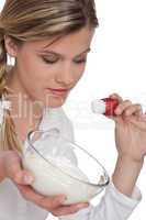 Healthy lifestyle series - Woman holding strawberry with yogurt