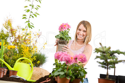 Gardening - Happy woman holding flower pot