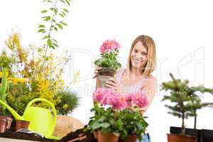 Gardening - Happy woman holding flower pot
