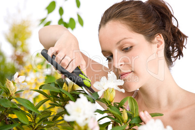 Gardening - woman cutting flower with pruning shears