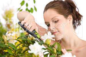 Gardening - woman cutting flower with pruning shears