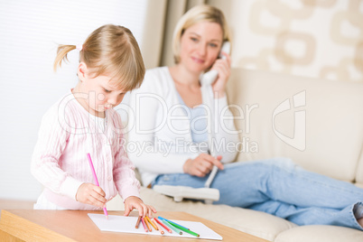 Little girl draw with color pencil in lounge