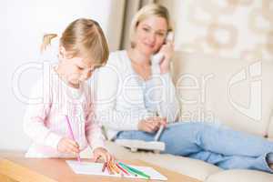Little girl draw with color pencil in lounge
