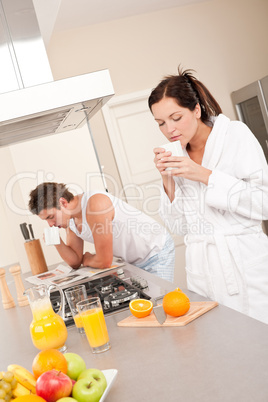 Woman having coffee for breakfast in the kitchen